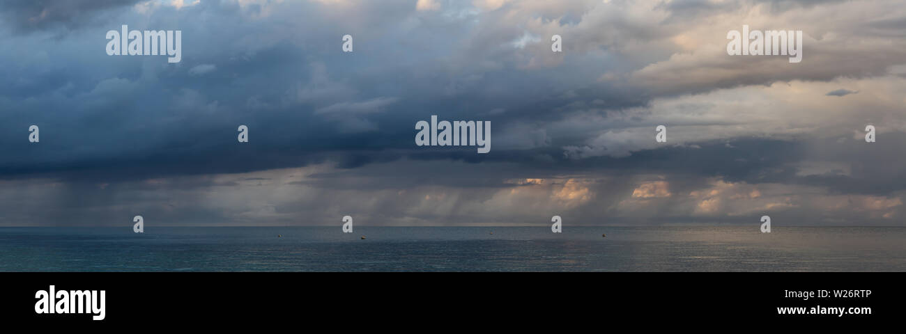 Dramatic clouds and sunlight during stormy weather over ocean hi-res ...