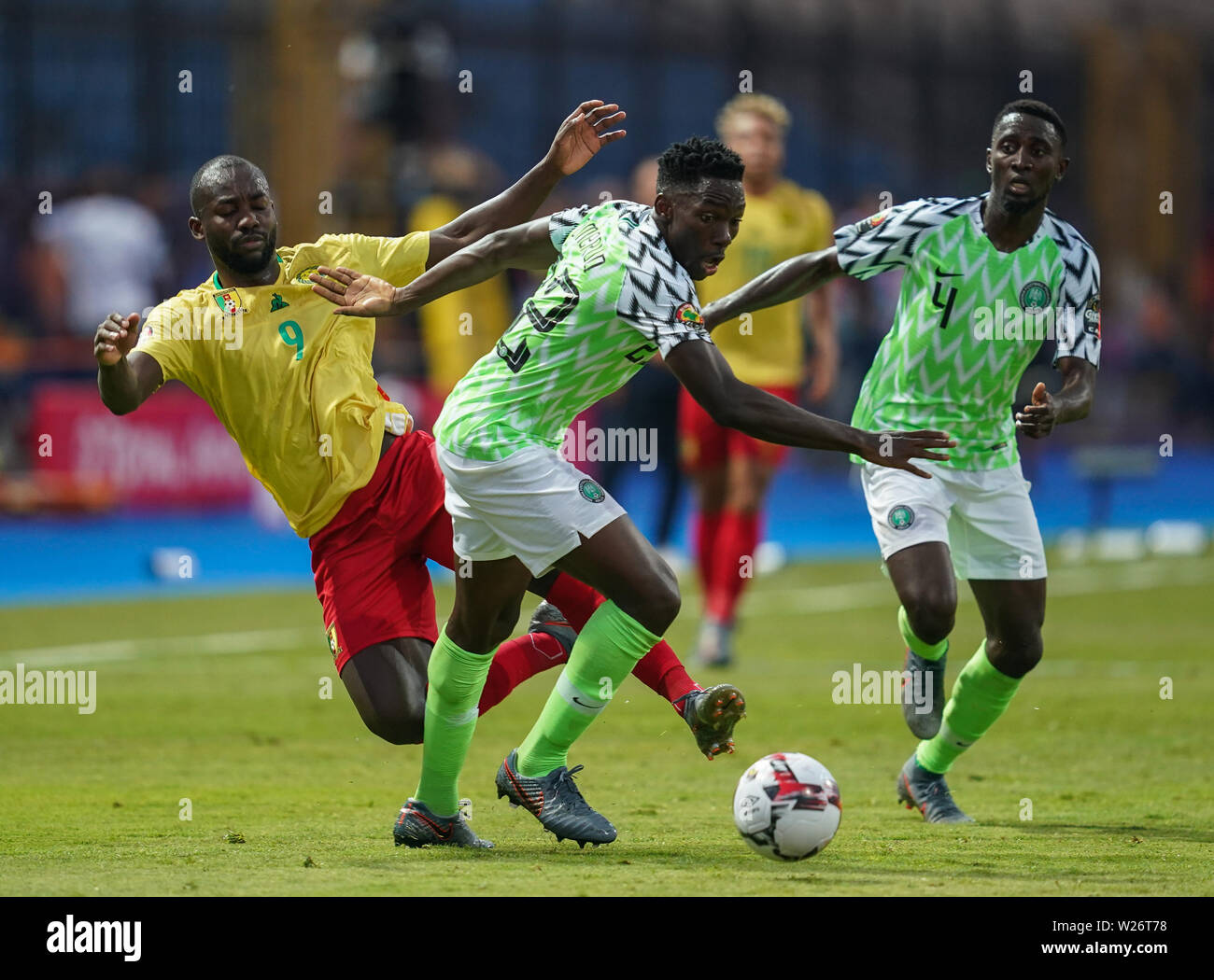 Alexandria, Egypt. 6th July 2019. FRANCE OUT July 6, 2019: Stephane Cedric Bahoken of Cameroon and Kenneth Josiah omeruo of Nigeria challenging for the ball during the 2019 African Cup of Nations match between Cameroon and Nigeria at the Alexanddria Stadium in Alexandria, Egypt. Ulrik Pedersen/CSM. Stock Photo