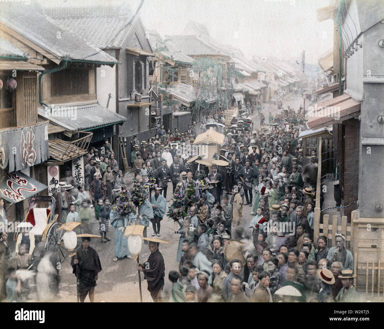 [ 1890s Japan - Japanese Funeral Procession ] —   A crowd gathers to watch a funeral procession.  19th century vintage albumen photograph. Stock Photo