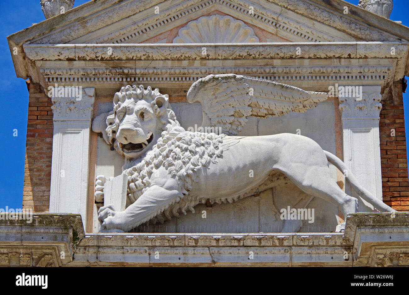 A carved stone representation of the Winged Lion which came to symbolise both Venice and St Mark, its patron saint.  Part of land gate to the Arsenal. Stock Photo