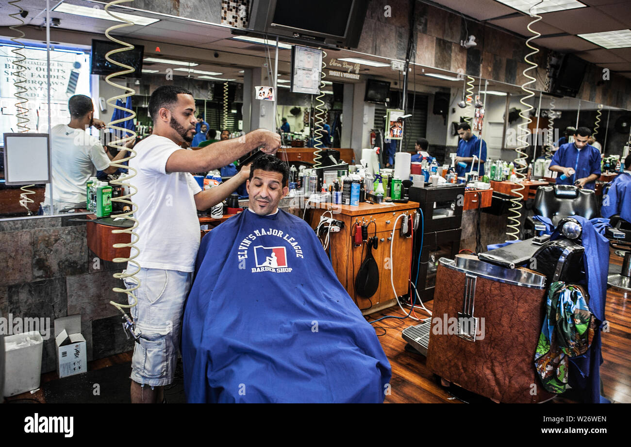 men getting their hair cut and styled  at a small business barber shop in Kensington Philadelphia Stock Photo