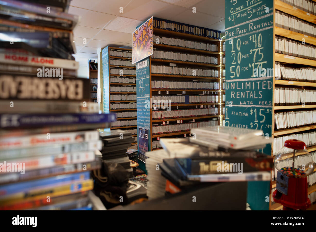 video store interior showing  piles of video disks for sale and rent Stock Photo