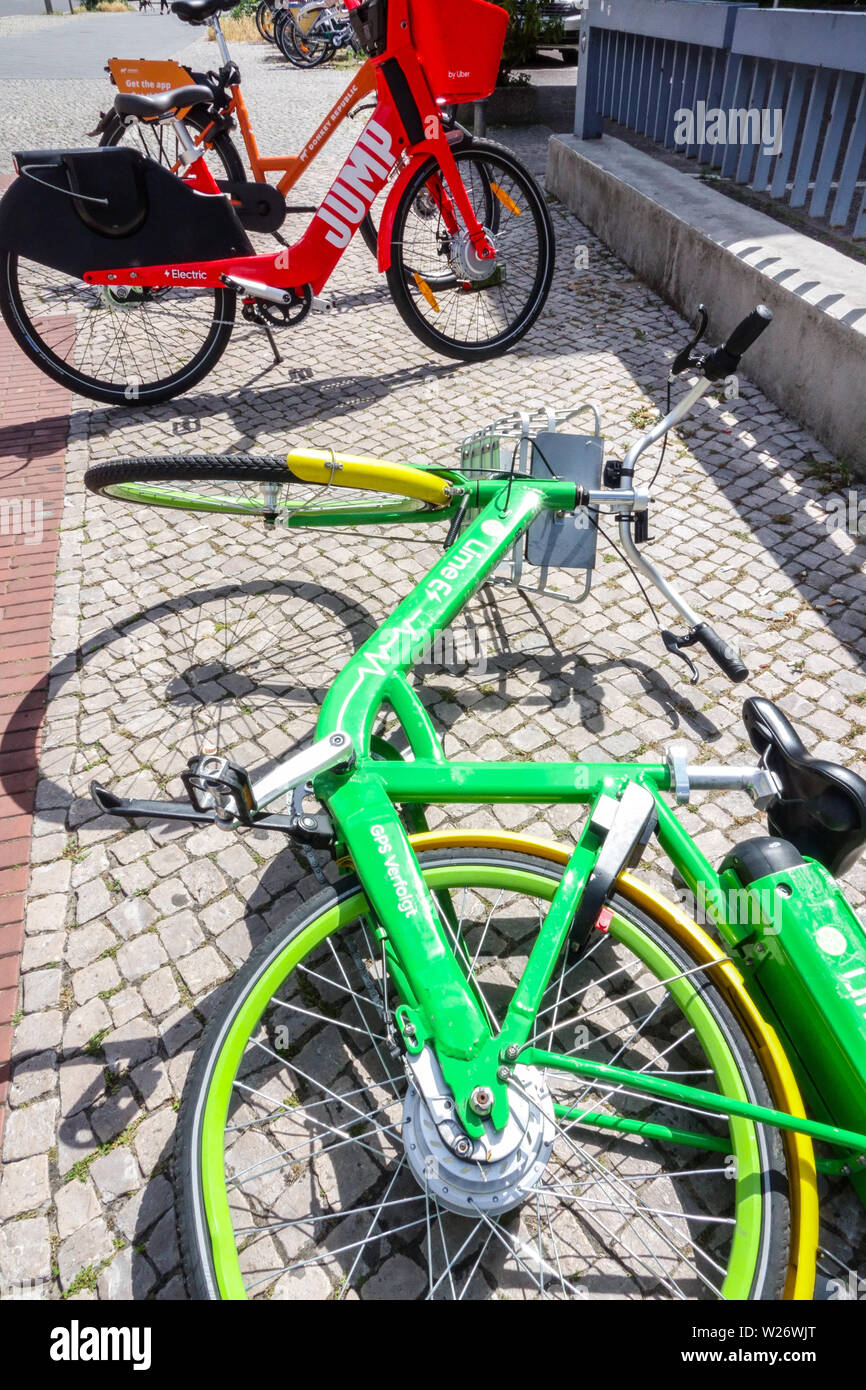 Rental electric bike bicycle by Uber, Lime, Sidewalk Berlin Germany Stock Photo