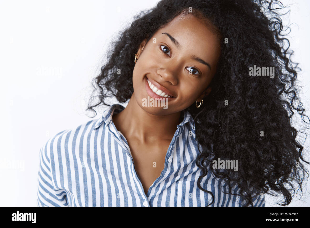 Comestology, skincare, lifestyle concept. Carefree young dark-skinned woman  tilt head joyfully smiling white teeth showing beautiful strong curly hair  Stock Photo - Alamy