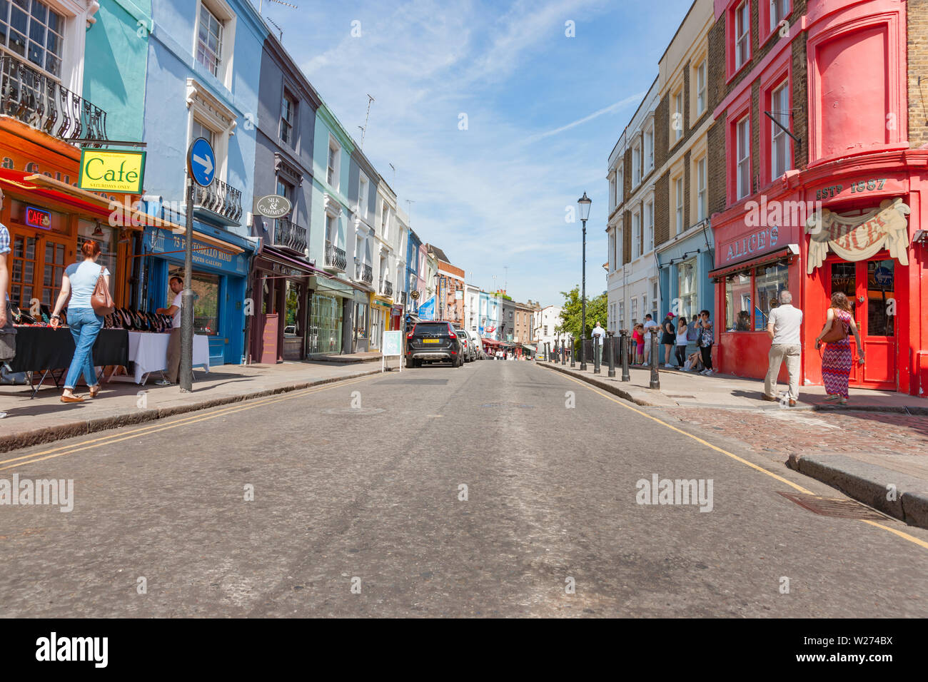 LONDON ENGLAND - JULY 15 2013;  People on street outside typically English old buildings and Alice's Antiques red fronted shop on Portobello Road. Stock Photo