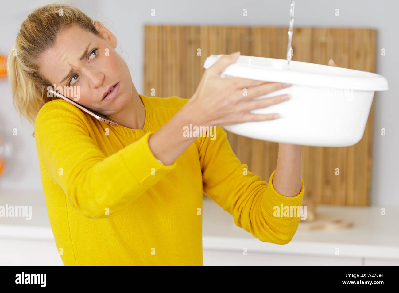 Upset Woman Calling Insurance For Water Leaks Stock Photo