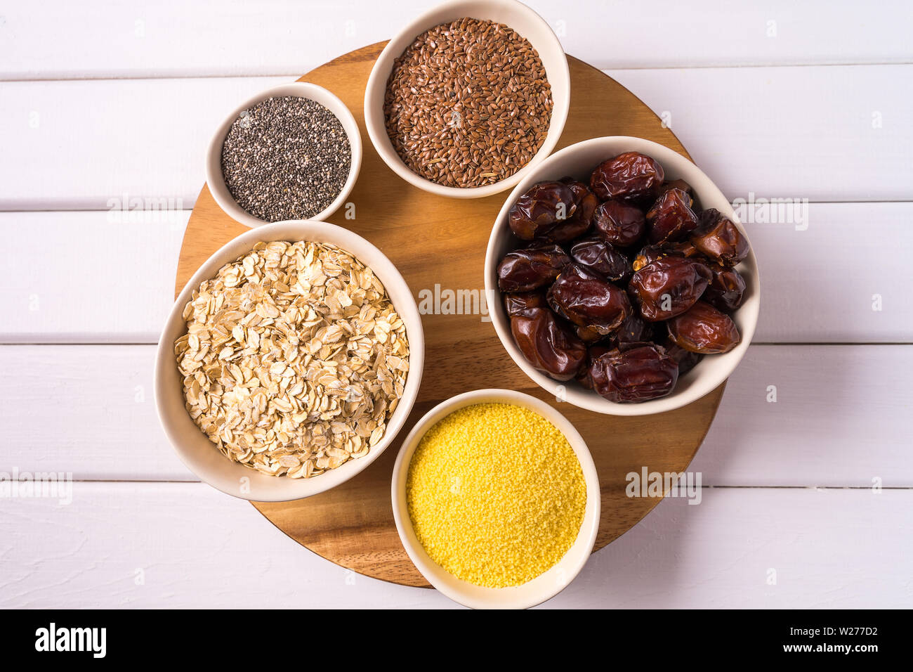 Top view the set of Superfoods in Bowls over white wooden Background. Stock Photo