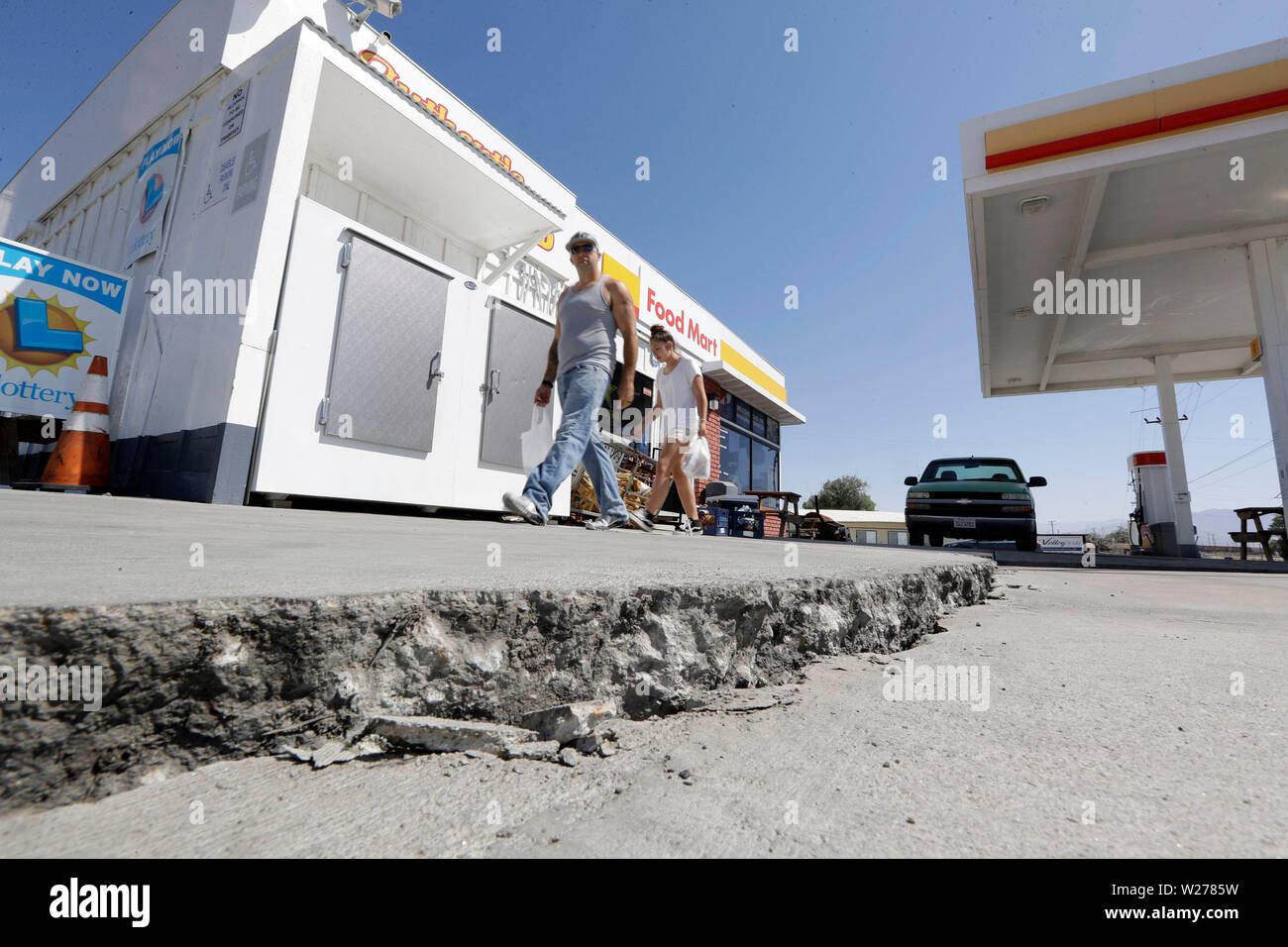A crack is seen in a gas station's driveway in the aftermath of an earthquake Saturday, July 6, 2019, in Trona, Calif. Crews in Southern California assessed damage to cracked and burned buildings, broken roads, leaking water and gas lines and other infrastructure Saturday after the largest earthquake the region has seen in nearly 20 years jolted an area from Sacramento to Las Vegas to Mexico. (AP Photo/Marcio Jose Sanchez) Stock Photo