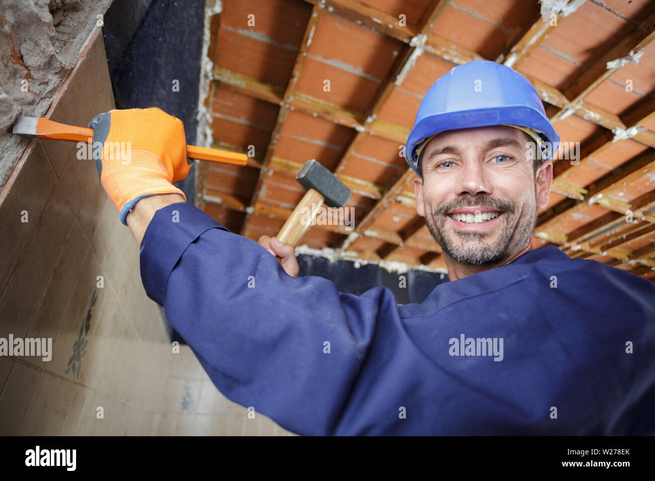 constructon worker using a hammer and chisel Stock Photo - Alamy