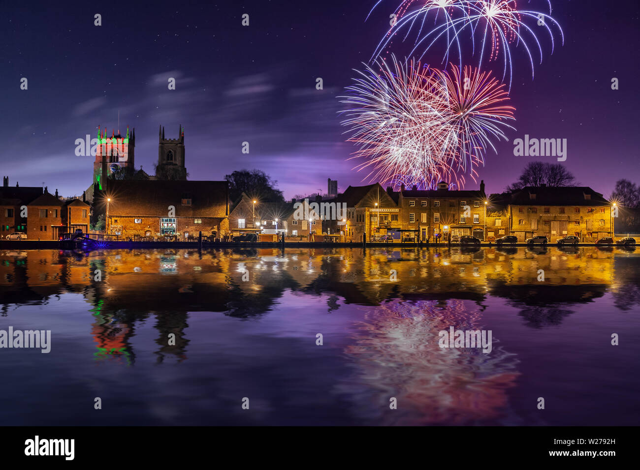 Fireworks at Kings Lynn in Norfolk UK 2018. Rockets exploding in a display over the Great River Ouse at night time. Historic town at night with reflec Stock Photo