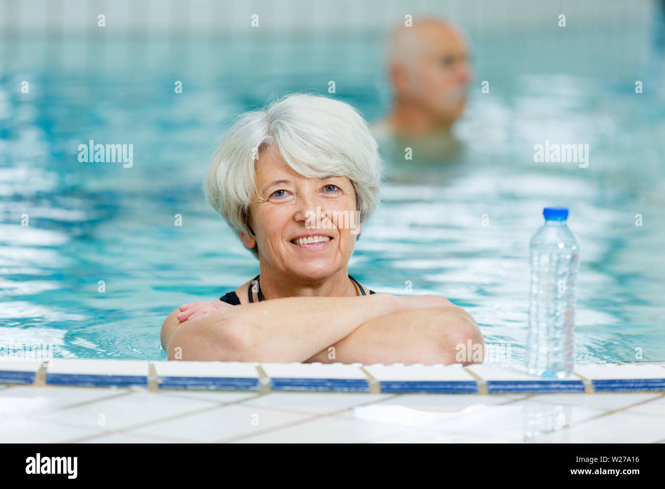 Older woman swimming in pool hi-res stock photography and images - Alamy