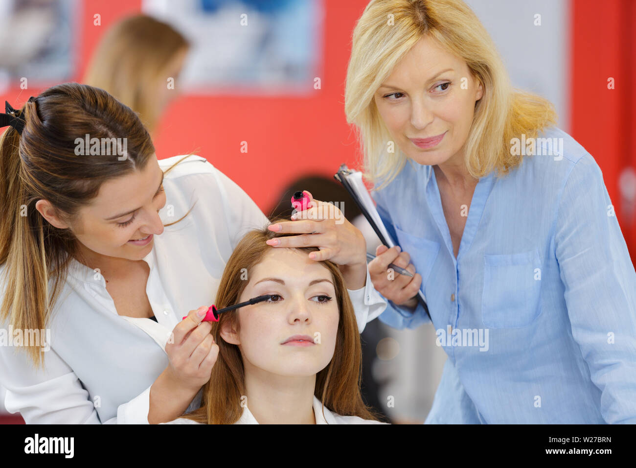 trainee beautician applying mascara to live model Stock Photo Alamy