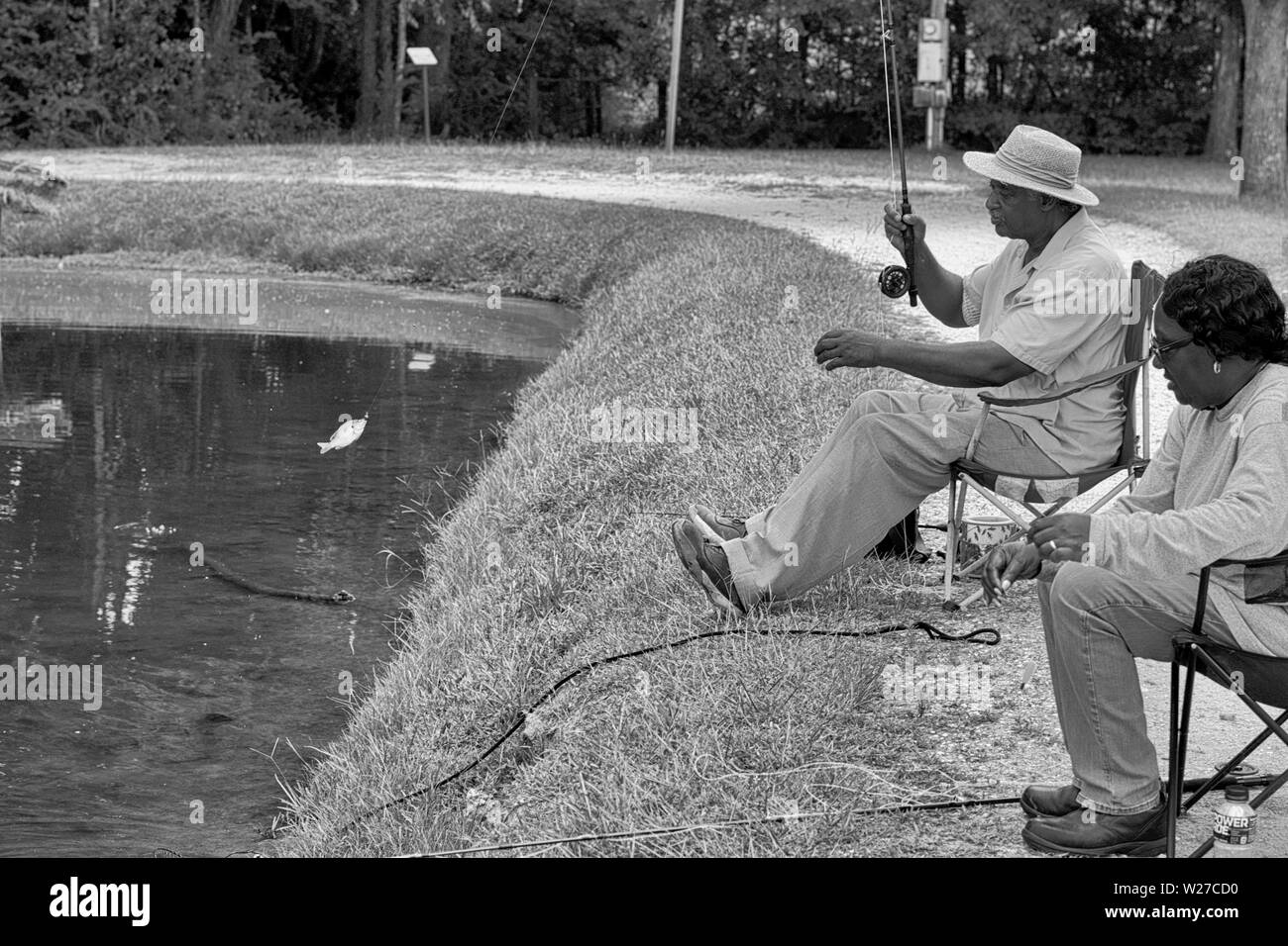 Reeling in a fish at a lake in Fayette, Al. Stock Photo