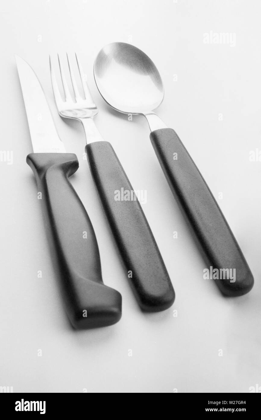 Cutlery: knife, fork, and spoon. B&W film. Stock Photo