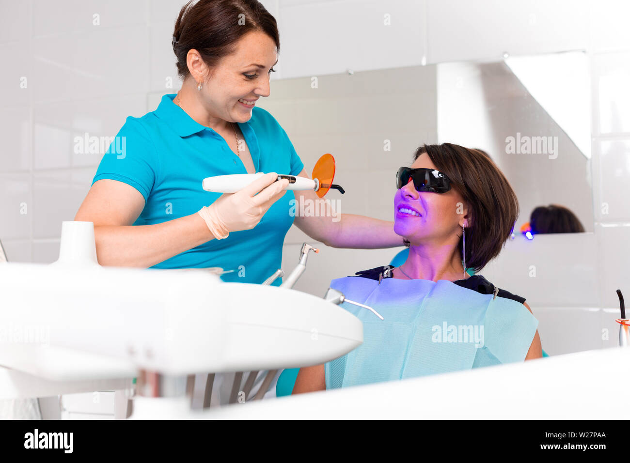 Closeup portrait of a female patient at dentist in the clinic. Teeth