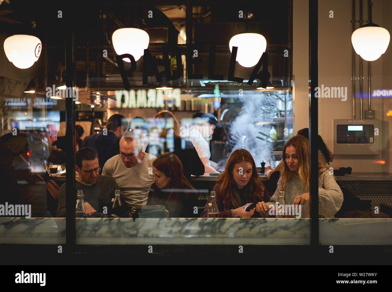 London, UK - February, 2019. Young people in a restaurant  in Borough market near London Bridge. Stock Photo