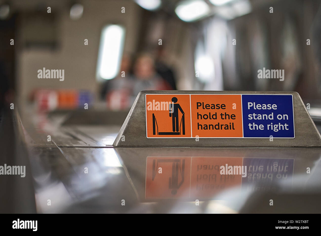 A 'Please stand on the right' sign on an escalator in a London Tube Station. Landscape format. Stock Photo