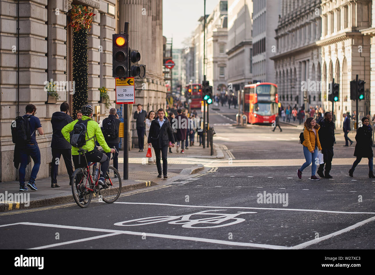 London, UK - February, 2019. A cycling commuter at a crossing in Bank, central London. Stock Photo