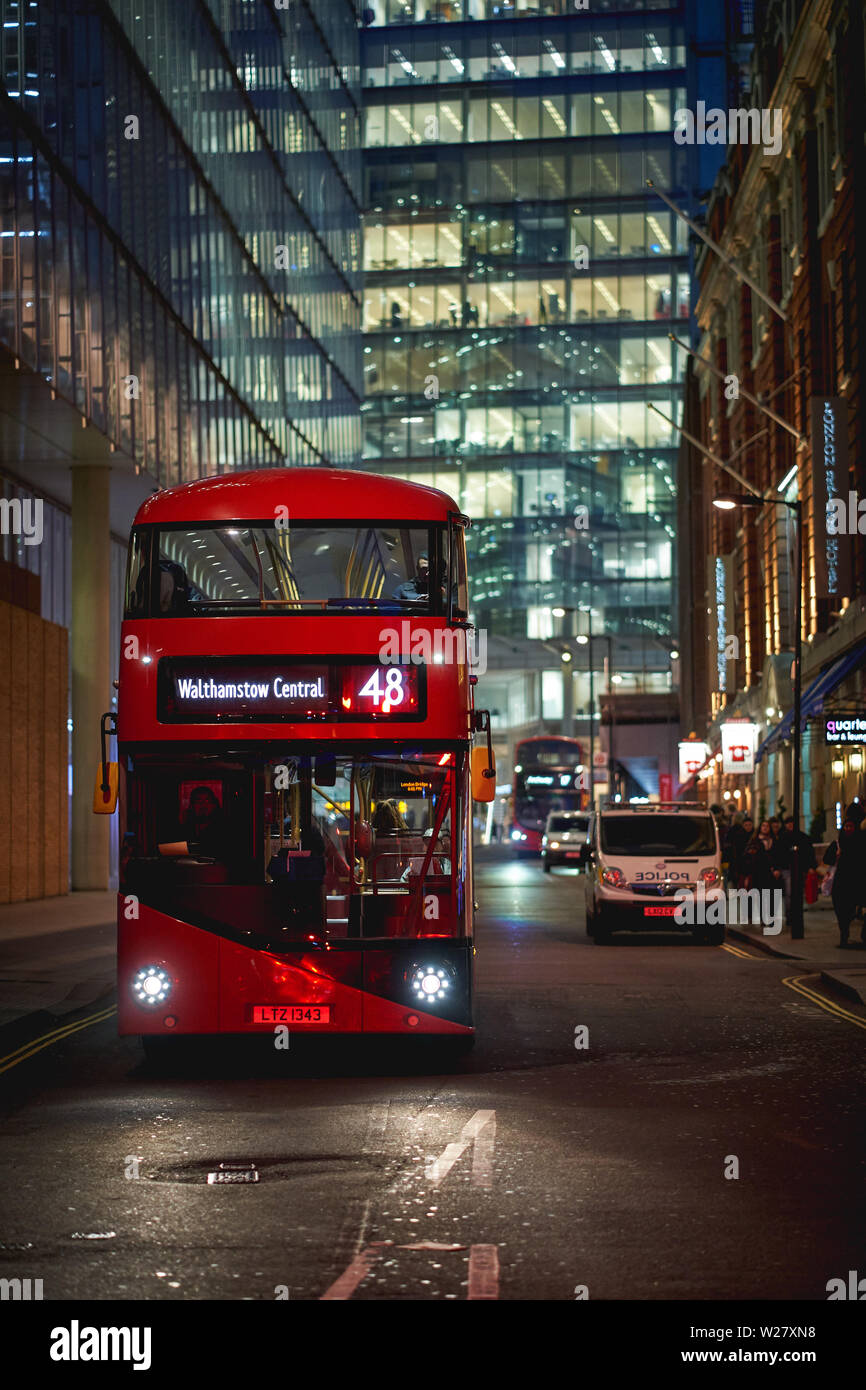London, UK - February, 2019. An iconic new red double-decker bus near London Bridge Station with the Shard on the background. Stock Photo