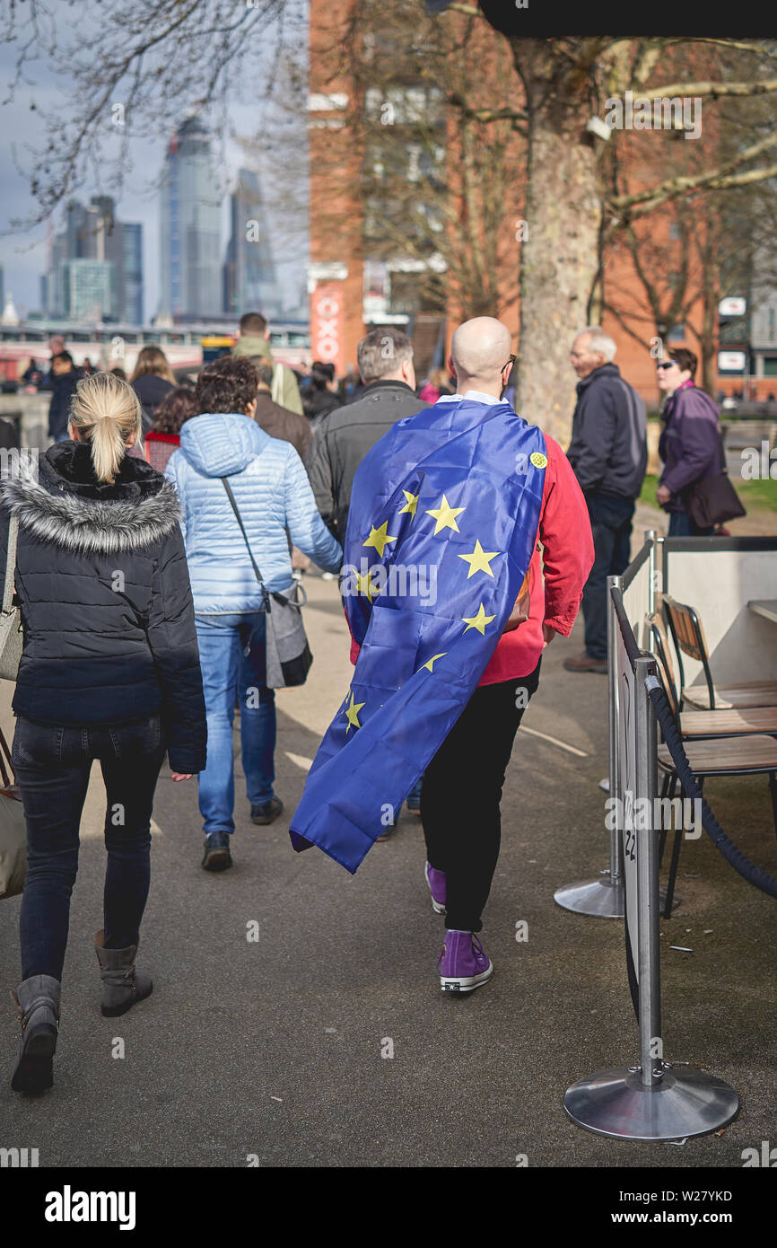 London, UK - April, 2019. A man wearing a European flag at a protest march against Brexit in central London. Stock Photo