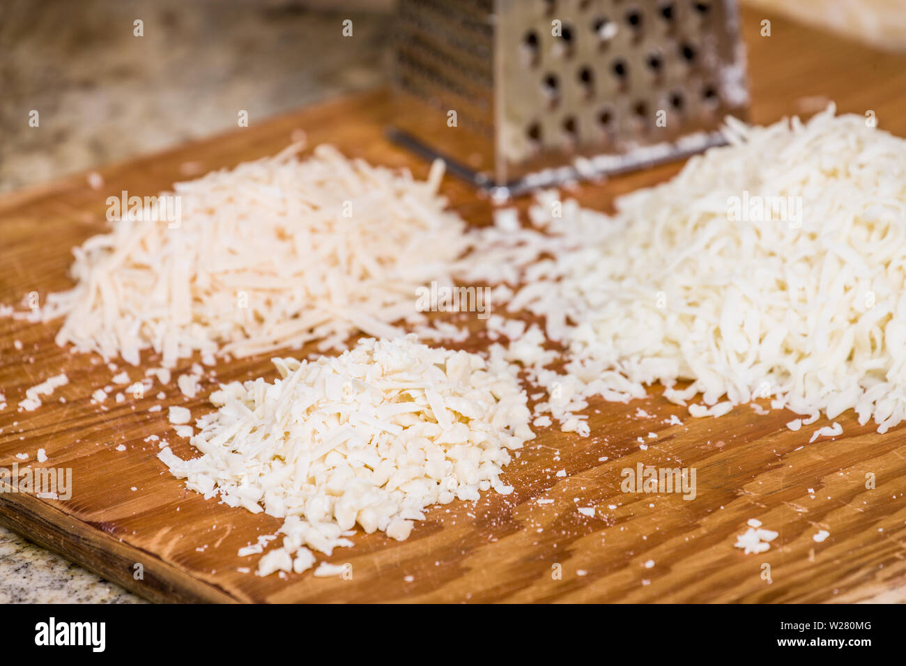 Using a variety (mozzarella, parmesan, romano) of grated cheeses on a