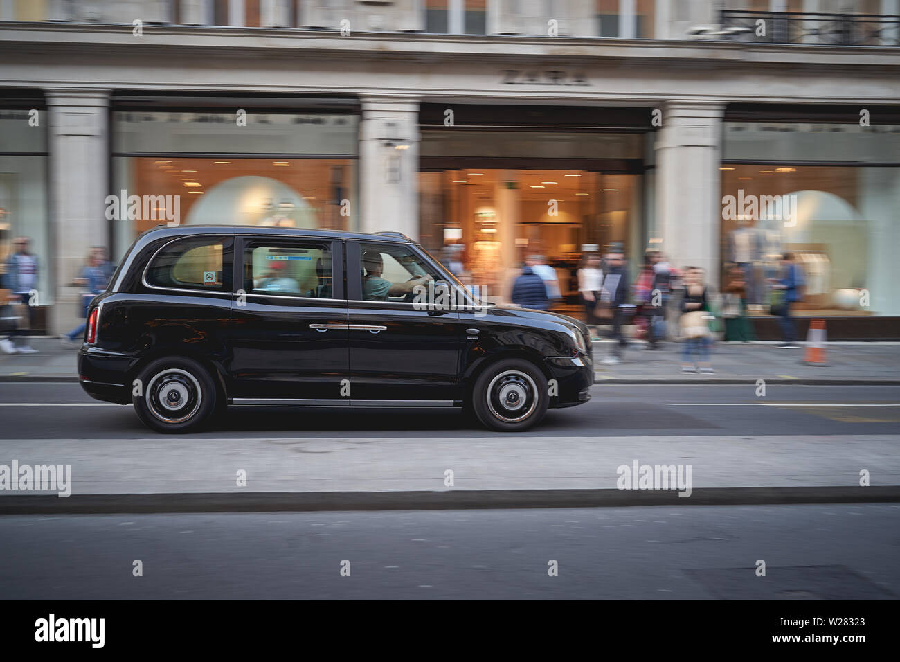London, UK - June, 2019. A new model taxi in Regent Street. Black cabs are the most iconic symbol of London as well as Red Double Decker Buses. Stock Photo
