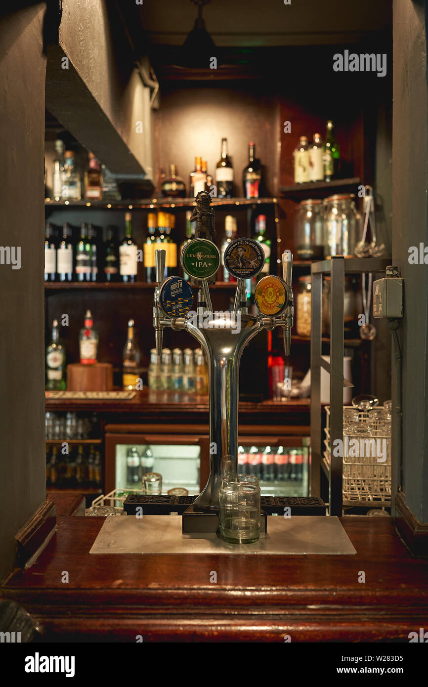 London, UK - May, 2019. Draught beer taps in a traditional pub in central London. Stock Photo