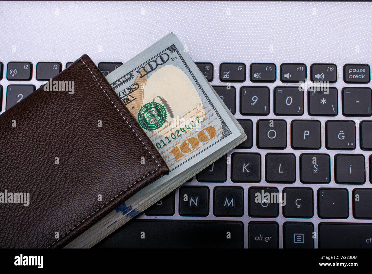 100 dollar bills on keyboard hi-res stock photography and images - Alamy