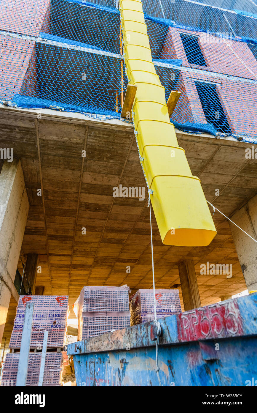 Valencia, Spain - July 3, 2019: Pipes to throw  debris into a construction site. Stock Photo