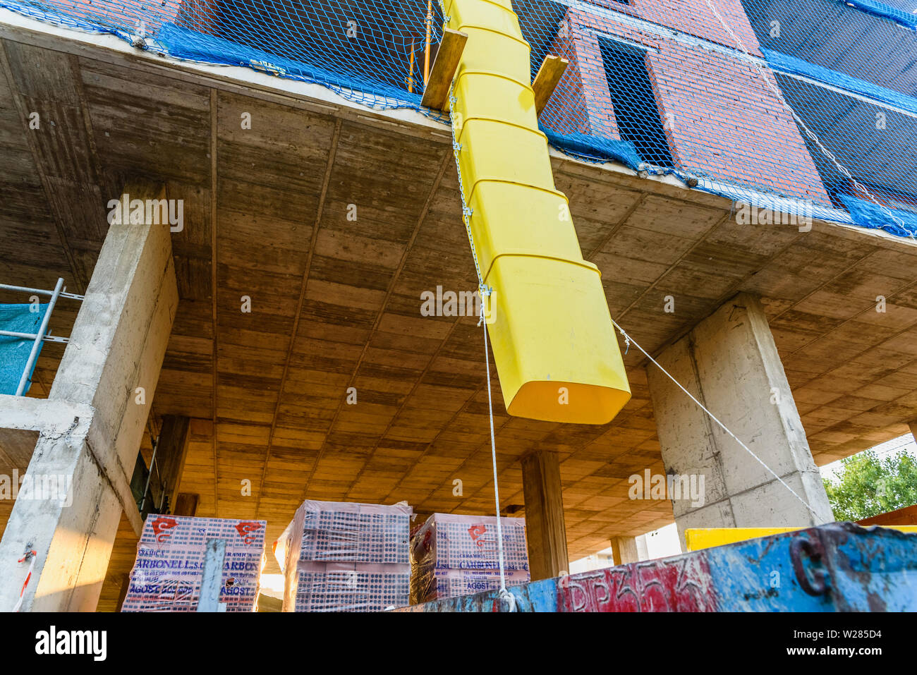 Valencia, Spain - July 3, 2019: Pipes to throw  debris into a construction site. Stock Photo