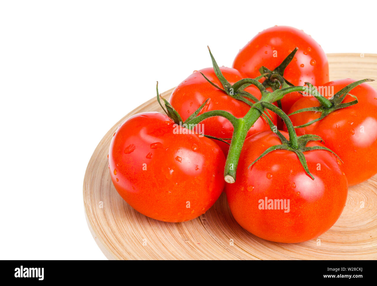 Branch of ripe red tomatoes on wooden dish Stock Photo - Alamy