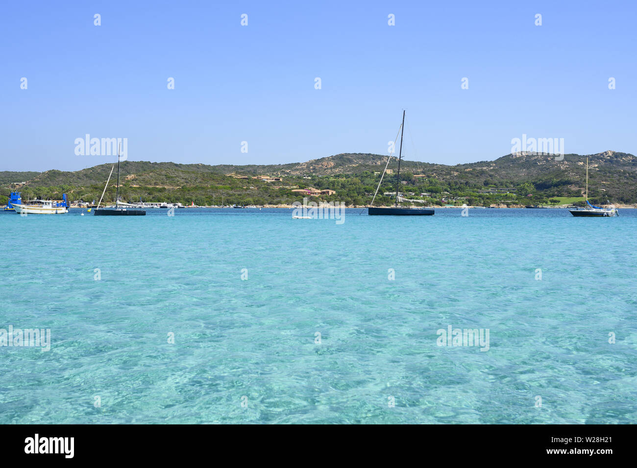 Stunning view of some yacht sailing on a beautiful turquoise clear water. Isola  Piana, Corsica, France Stock Photo - Alamy