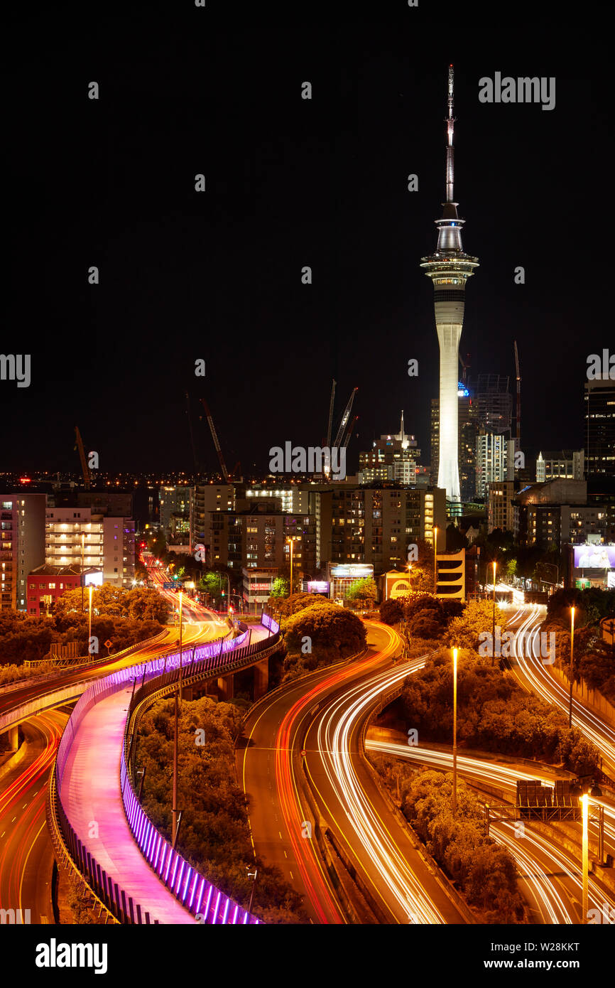 Motorways, Lightpath cycleway, and Sky Tower at night, Auckland, North Island, New Zealand Stock Photo