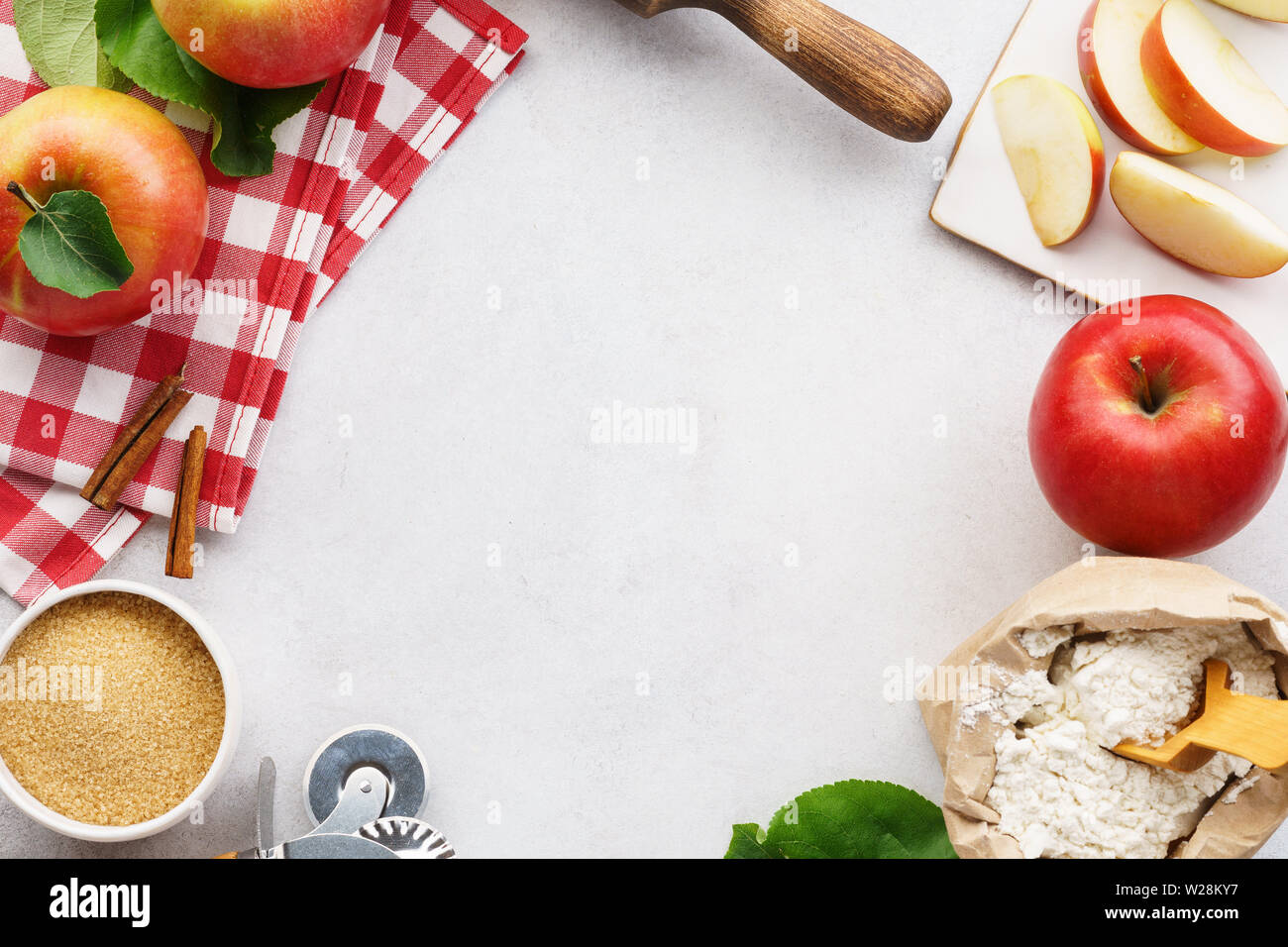 Ingredients and tools for making an apple pie. Seasonal sweet pastry frame background with copy space. Stock Photo