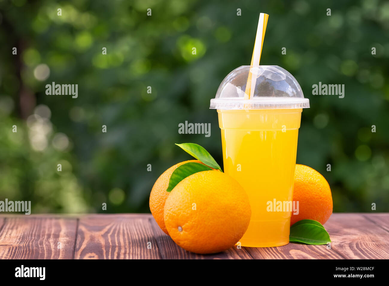orange juice in plastic cup Stock Photo - Alamy