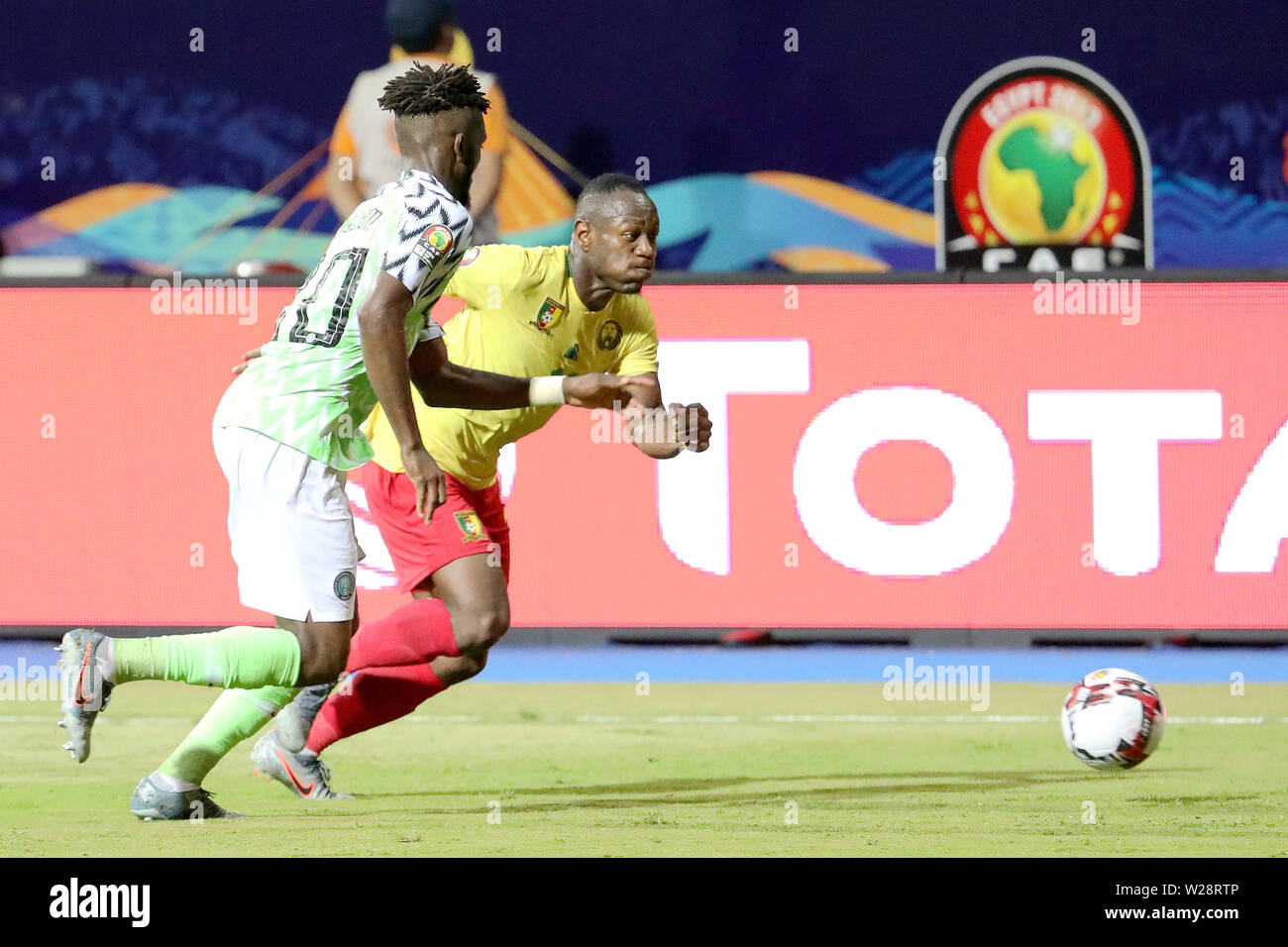 Alexandria, Egypt. 6th July, 2019. Christian Mougang Bassogog (R) of Cameroon vies with Chidozie Collins Awaziem of Nigeria during the round of 16 match between Nigeria and Cameroon at the 2019 African Cup of Nations in Alexandria, Egypt, July 6, 2019. Credit: Wang Teng/Xinhua/Alamy Live News Stock Photo