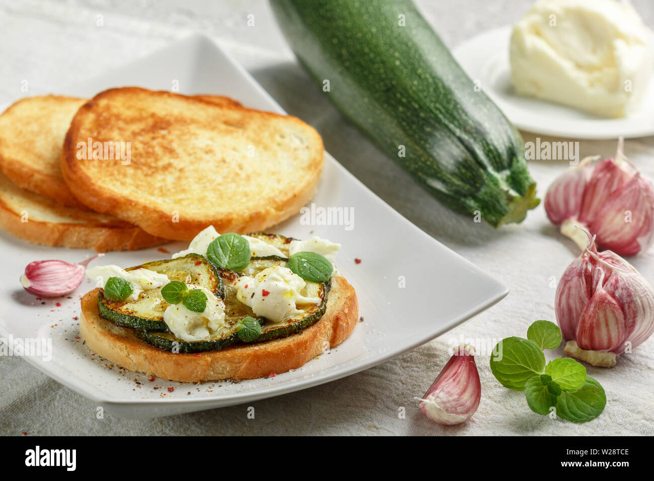 Delicacy bruschetta with fried or baked zucchini, mozzarella cheese