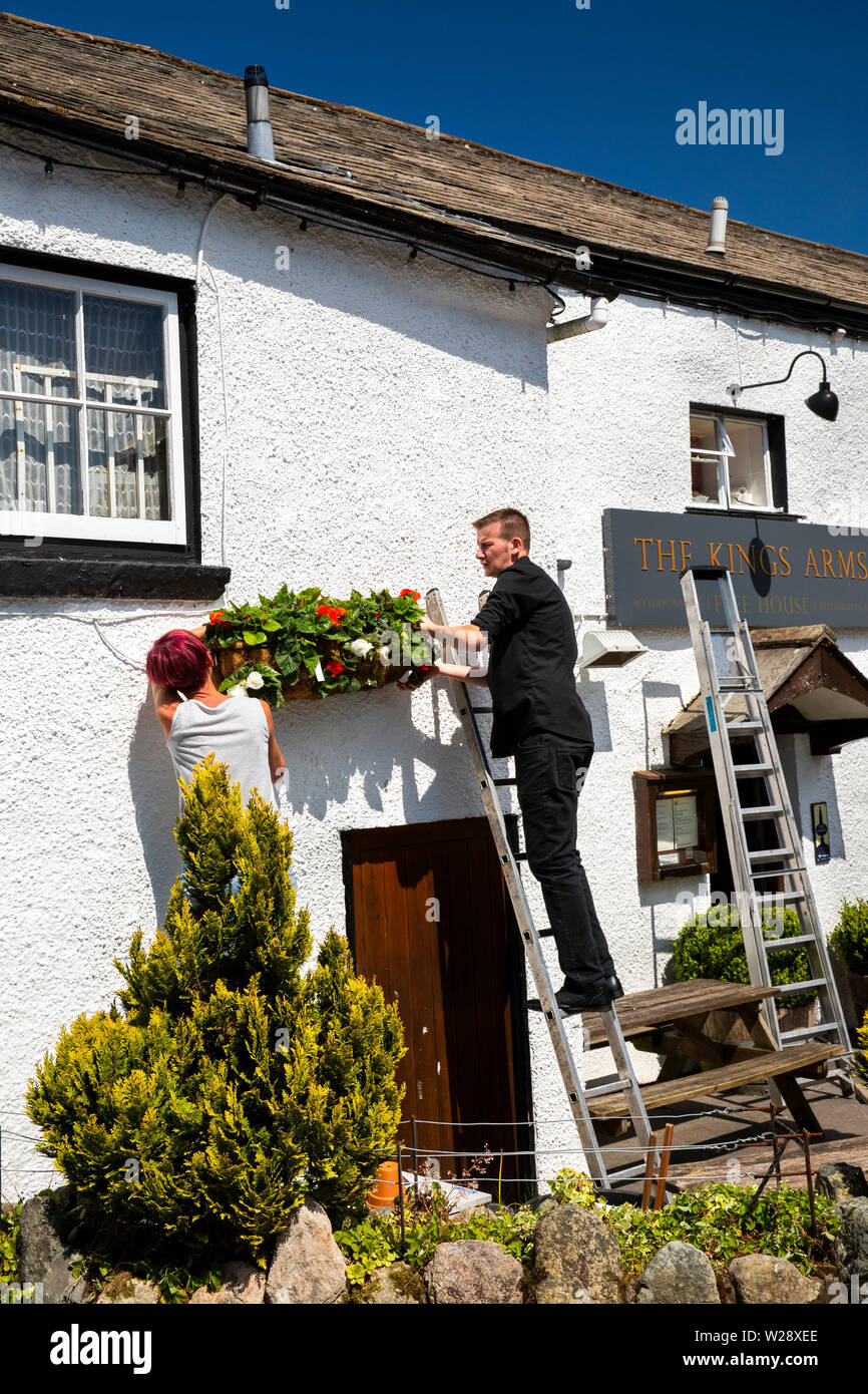 UK, Cumbria, Hawkshead, The Square, dressing the Kings Arms Hotel with floral planters in early summer Stock Photo