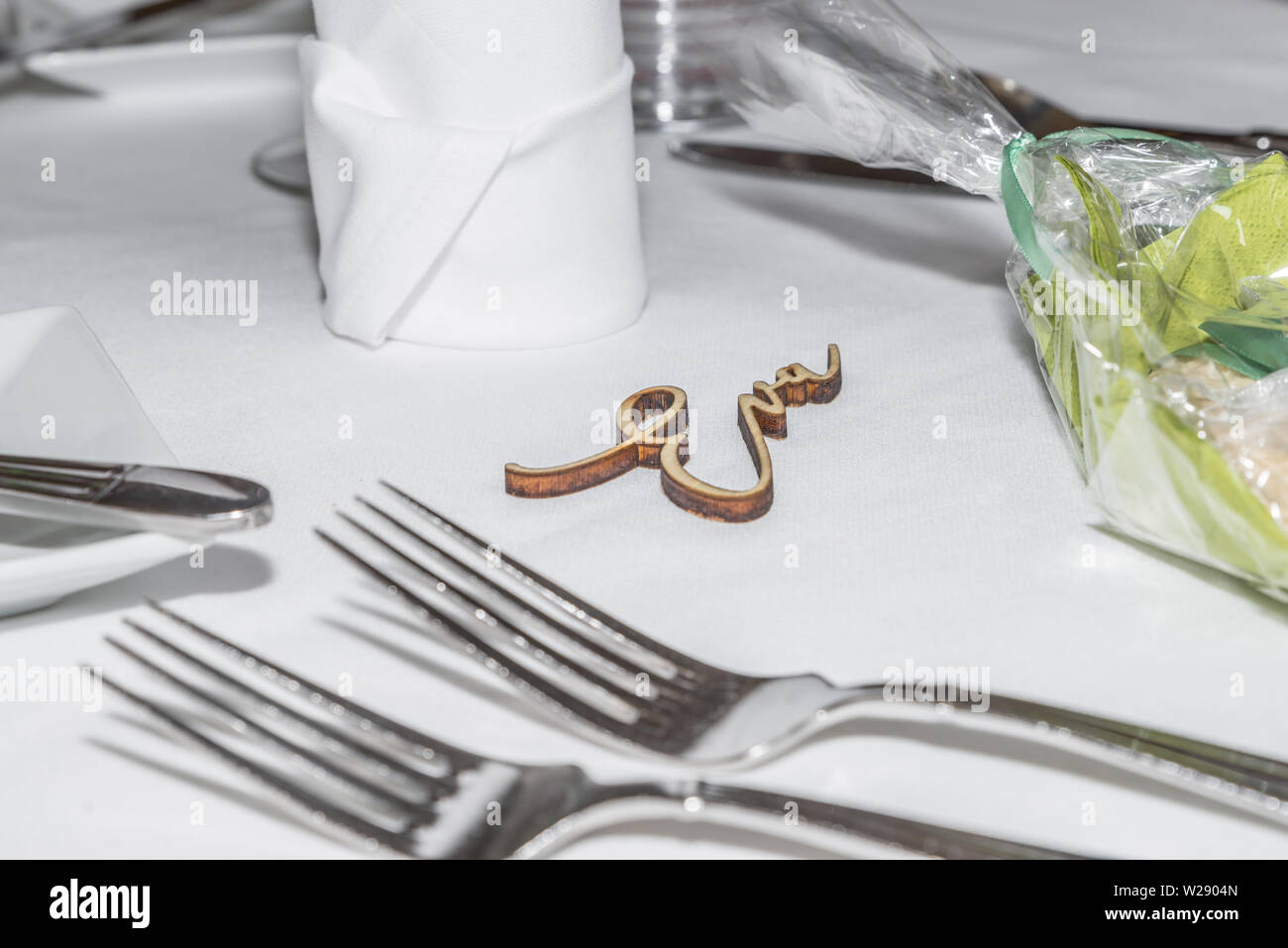 Table decoration of a wedding with glasses of cutlery and the name Eva, Germany Stock Photo