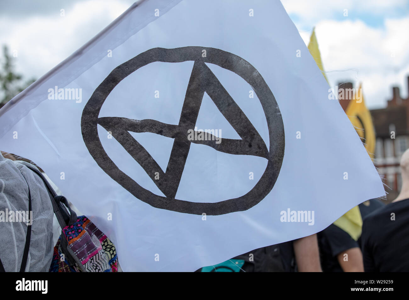 London, UK. 2nd July 2019. Flag of Extinction Rebellion, today creating a silent procession to and theatre in front of several fossil fuel companies. The protest play is based on Bizet's opera Carmen, with real life actors and an opera singer. Credit: Joe Kuis / Alamy News Stock Photo