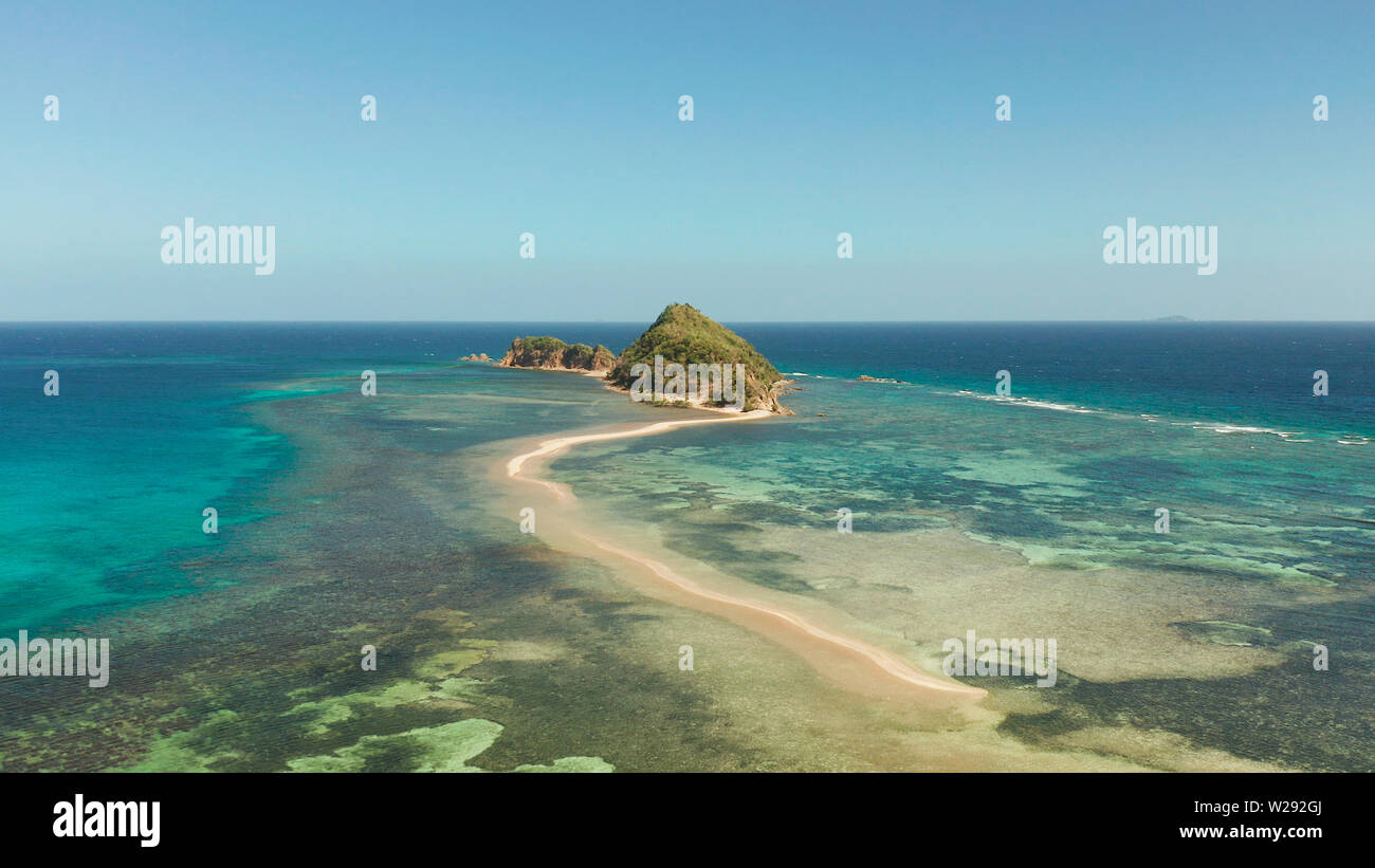 aerial view tropical island in blue lagoon, coral reef and sandy beach ...