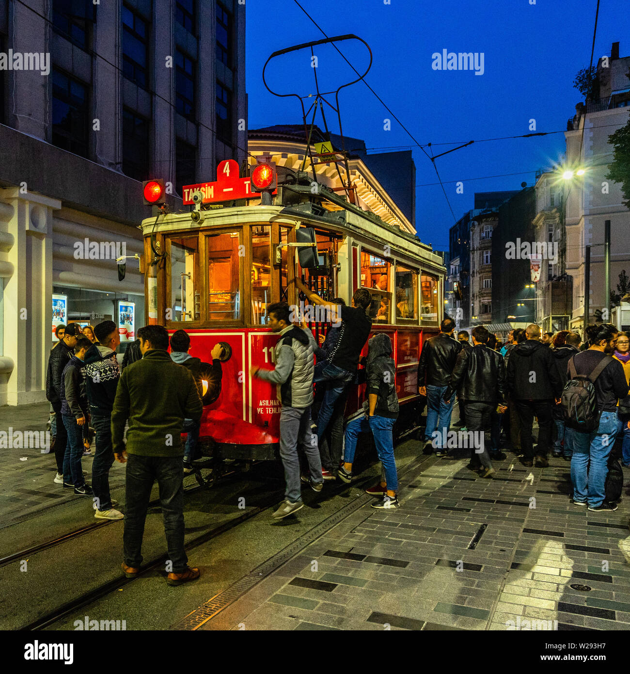Famous Istanbul red tram full of people at rush hour in Istiklal Street. Istanbul, Turkey, October 2018 Stock Photo