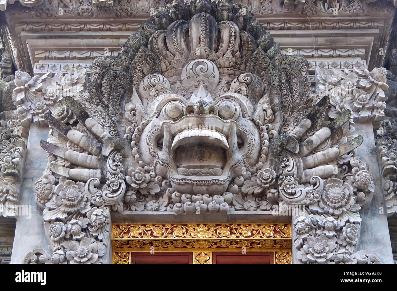 Close up picture of a typical Balinese stone mask sculpture that can be found at the most temples around Bali. This one is located at the Saraswati te Stock Photo