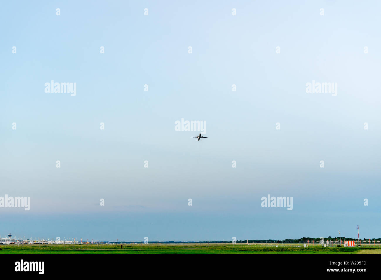 departure of an airplane with bottom view staying in a field Stock Photo