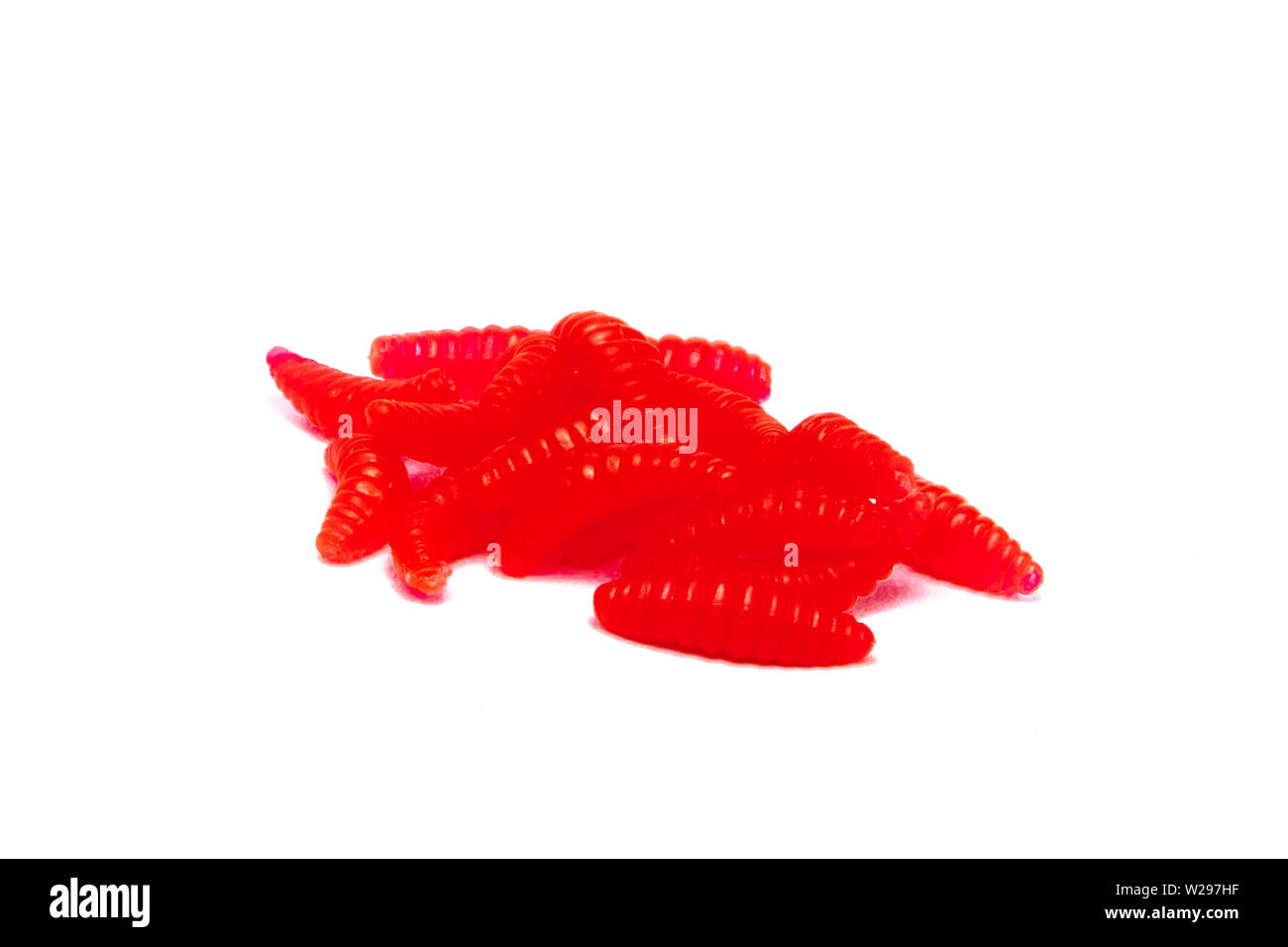 Red Artificial fishing larvae of insects on white background with soft shadow. Stock Photo
