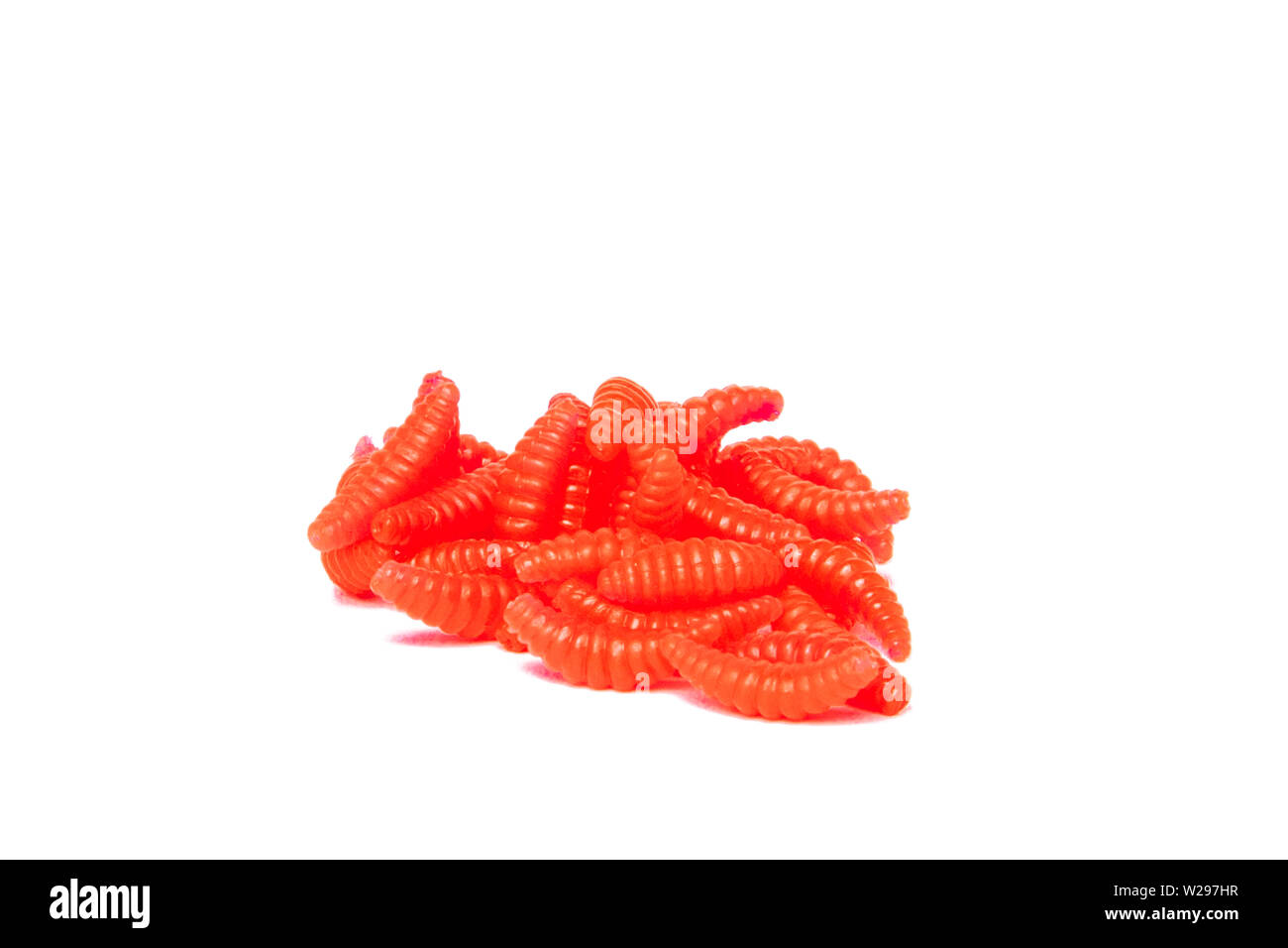 Red Artificial fishing larvae of insects on white background with soft shadow. Stock Photo