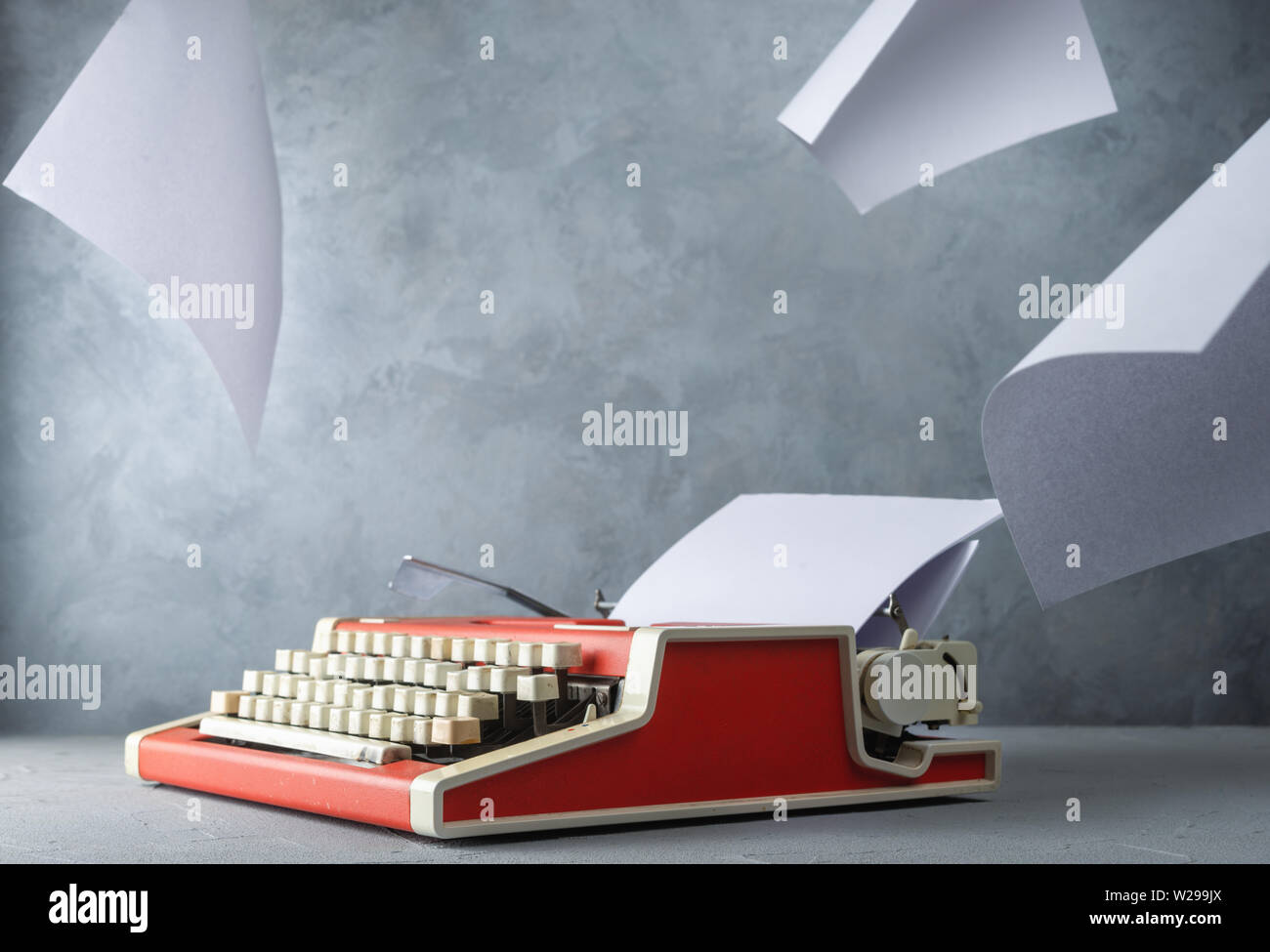 Typewriter on the table with paper sheets Stock Photo