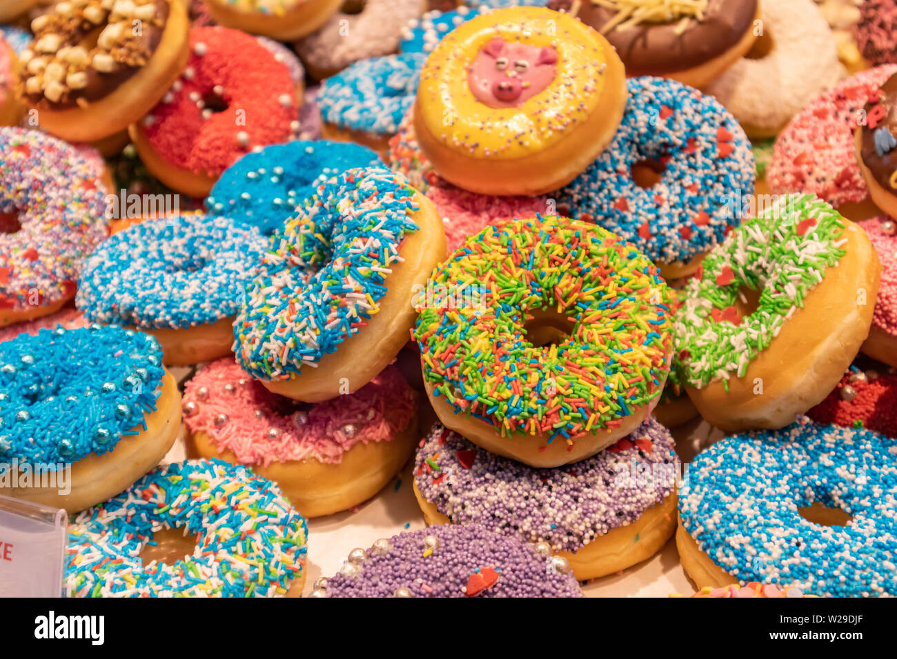 Assorted donuts, bakery display. Colorful donuts assortment background. Close up view Stock Photo