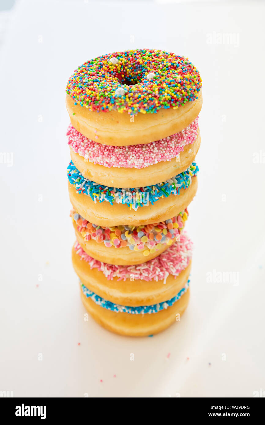 Assorted donuts. Colorful donuts assortment pile on white color background. Top view, banner Stock Photo
