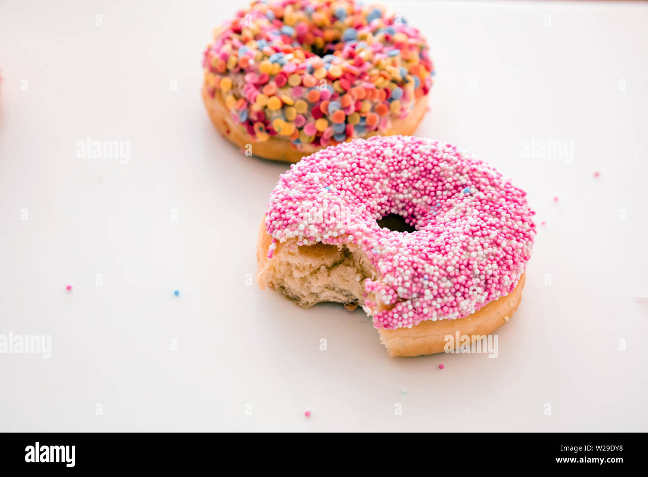 Delicious donuts. Pink and pastel colors decoration on white color background, copy space, closeup view Stock Photo